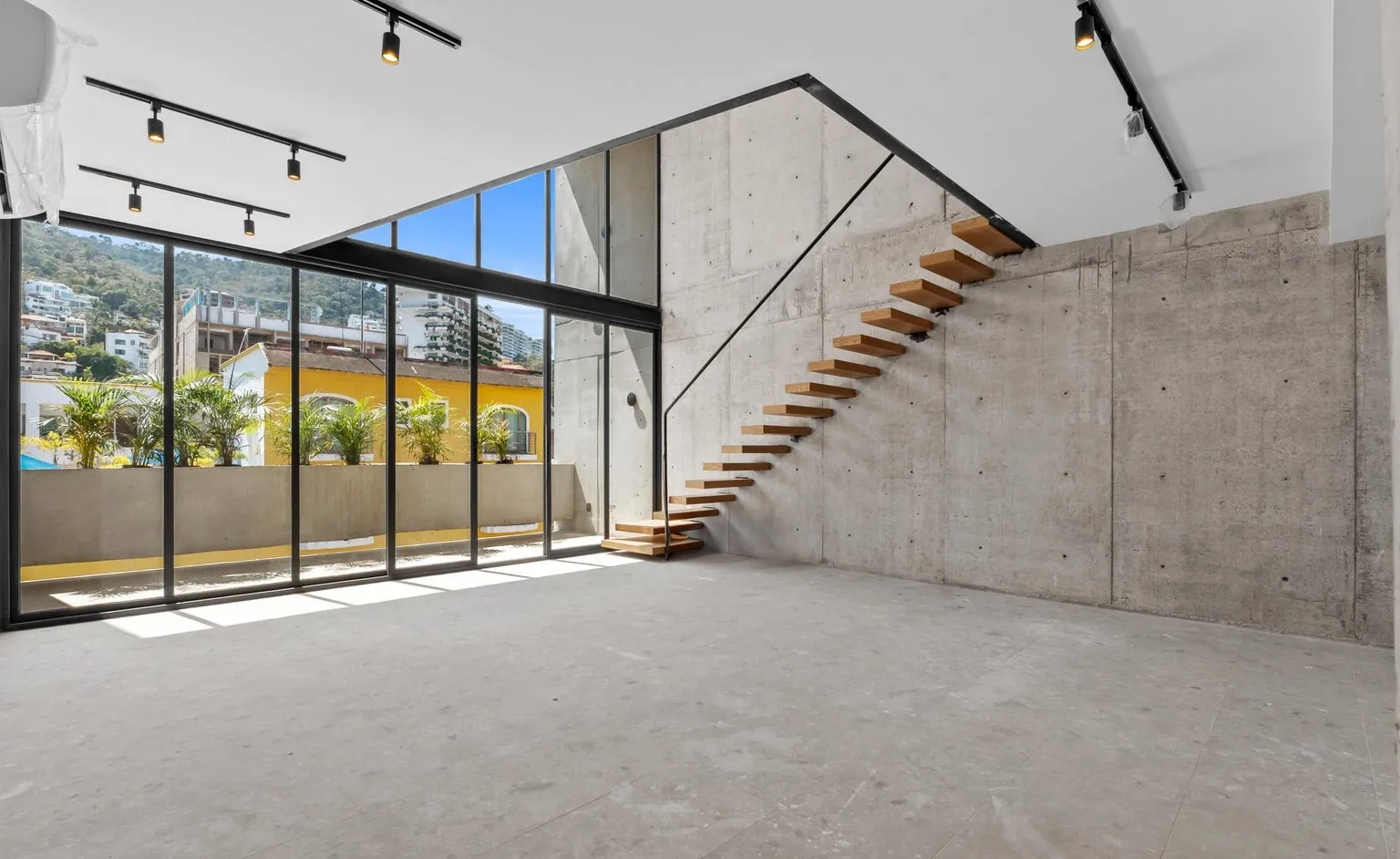 Double-height living room with floating stair